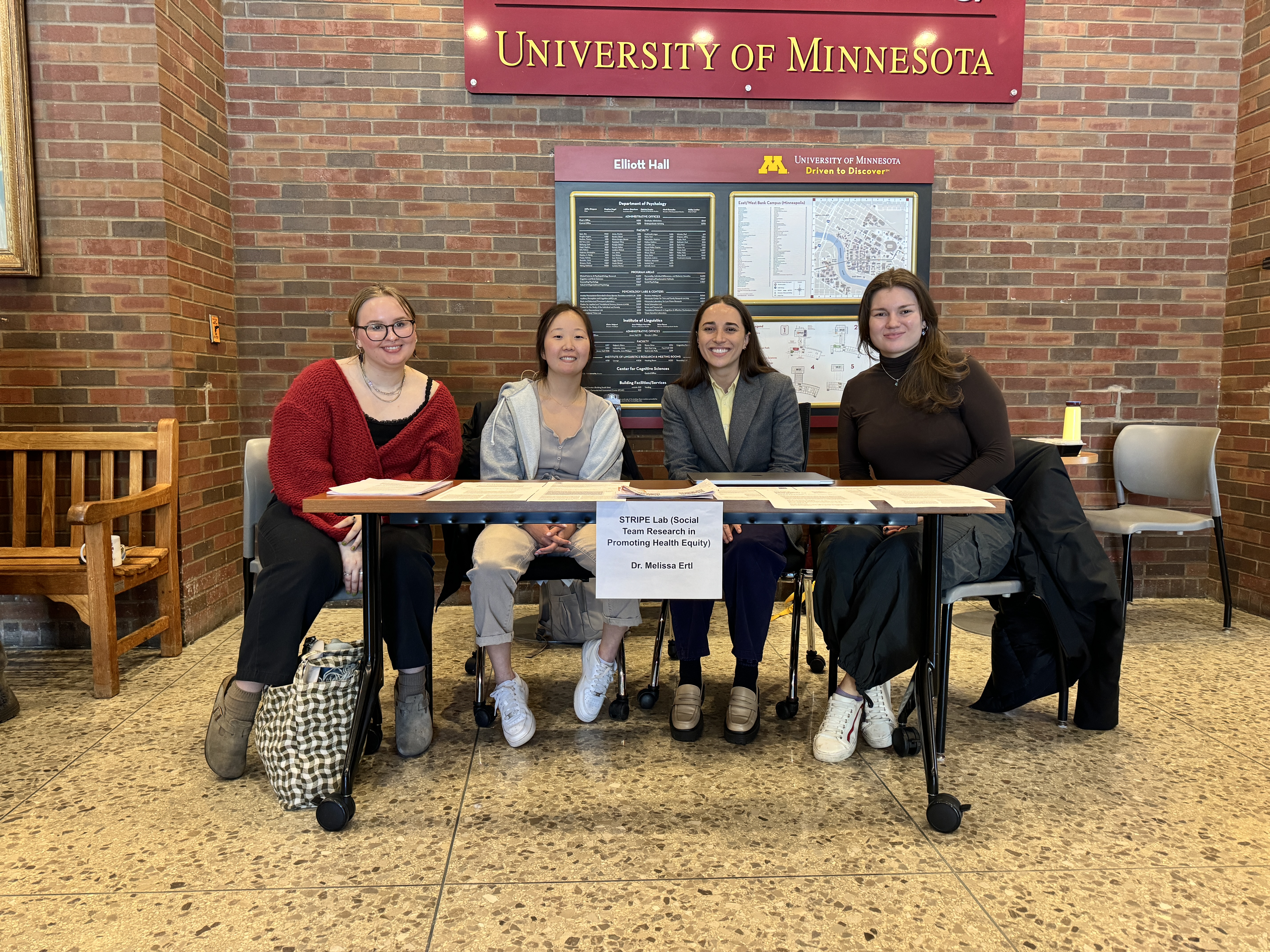 Members of the STRIPE Lab participated in the UMN Psychology Undergraduate Research Fair in late March 2024! Two undergraduate students (Meri Bosnic and Sara Jeremiason), one graduate student (Amelia Blankenau), and Dr. Melissa Ertl sit at a table at the fair.